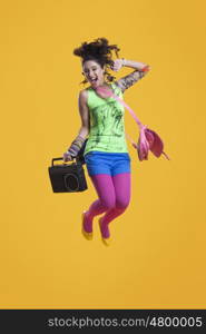 Portrait of funky woman jumping in mid air