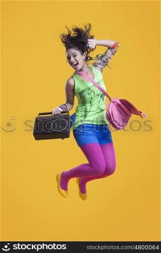 Portrait of funky woman jumping in mid air