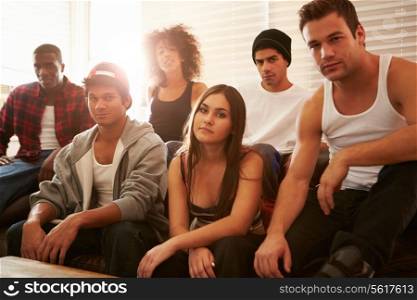Portrait Of Gang Members Sitting On Sofa In House