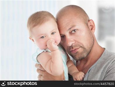 Portrait of gentle father with little daughter on hands at home, enjoying parenthood, young loving family, tenderness and love concept&#xA;