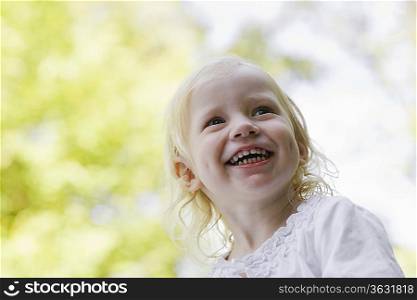 Portrait of girl (1-2) laughing outdoors
