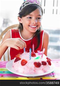 Portrait of girl (7-9) with birthday cake