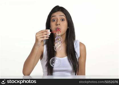 Portrait of girl blowing bubbles