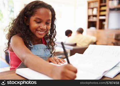 Portrait Of Girl Doing Homework At Table