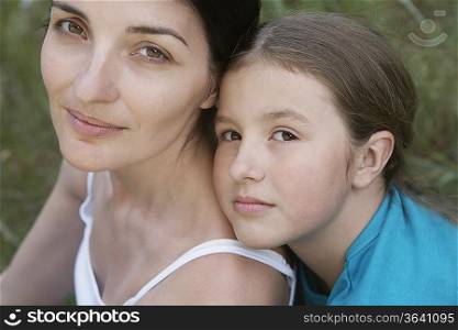 Portrait of girl embracing her mother, close-up