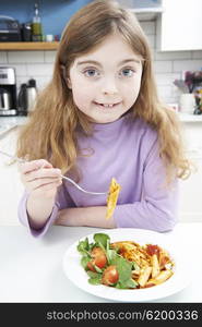 Portrait Of Girl Enjoying Healthy Meal At Home