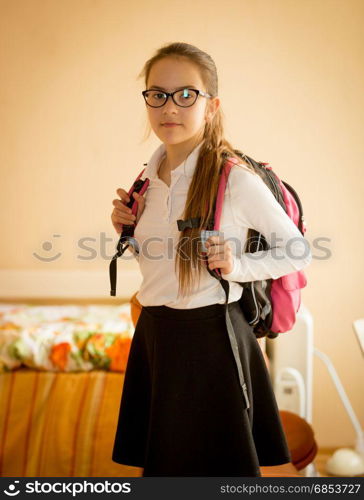 Portrait of girl getting ready for school at bedroom