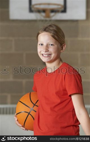 Portrait Of Girl Holding Basketball In School Gym