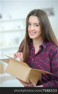 Portrait of girl holding open cardboard box