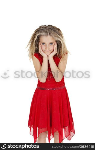 Portrait of girl in red frock with head in hands over white background