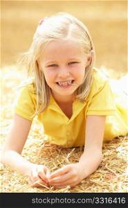 Portrait Of Girl Laying In Summer Harvested Field