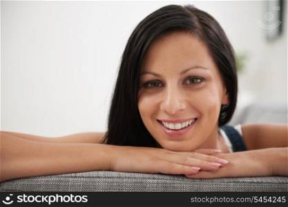 Portrait of girl laying on sofa in living room