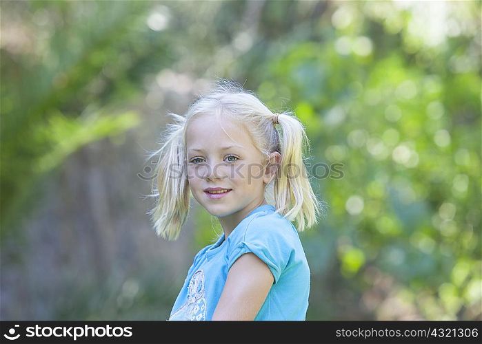Portrait of girl looking away in garden