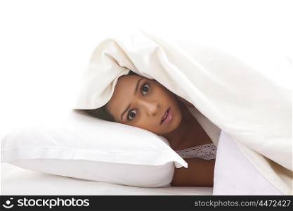 Portrait of girl lying on bed surprised