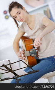 portrait of girl playing acoustic guitar