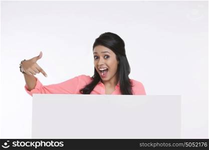 Portrait of girl pointing at white board