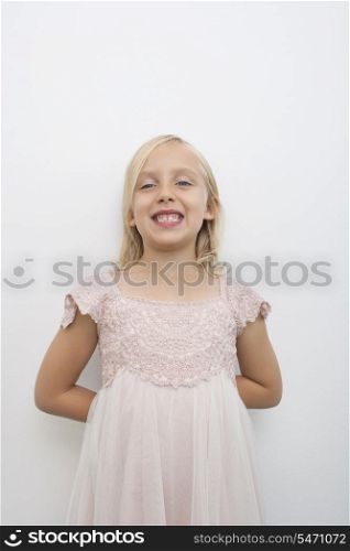 Portrait of girl smiling against white background