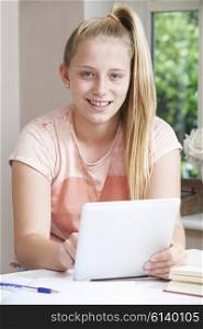 Portrait Of Girl Using Digital Tablet At Home