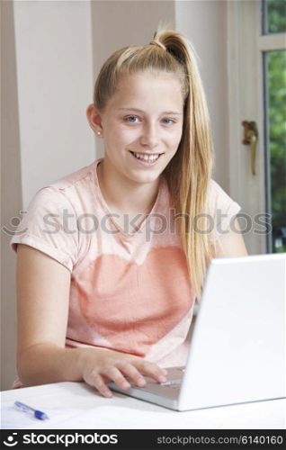 Portrait Of Girl Using Laptop At Home