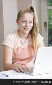 Portrait Of Girl Using Laptop At Home