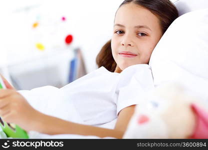 Portrait of girl with a book in bed at home