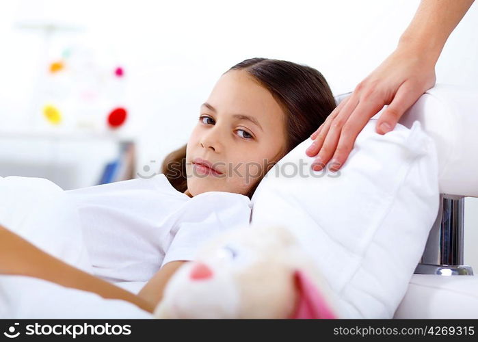 Portrait of girl with a book in bed at home