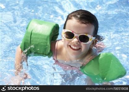 Portrait Of Girl With Armbands In Swimming Pool