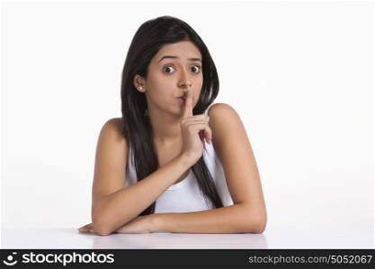 Portrait of girl with finger on lips