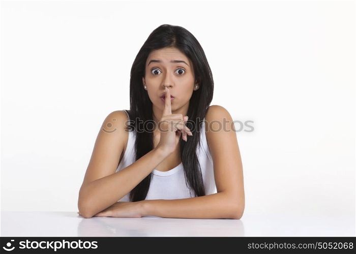 Portrait of girl with finger on lips