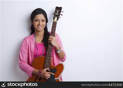 Portrait of girl with guitar smiling