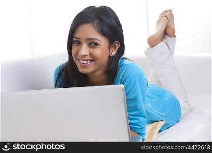 Portrait of girl with laptop smiling