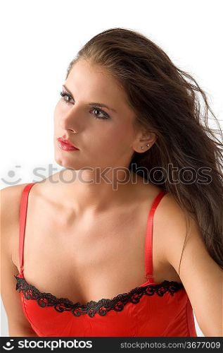 portrait of girl with moved hair and dreaming look wearing a red corset