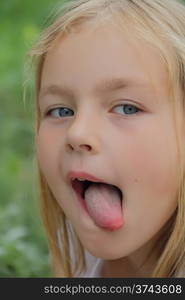 Portrait of girl with put out tongue