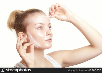 Portrait of girl young woman in facial peel off mask isolated on white. Peeling. Beauty and body skin care. Studio shot.