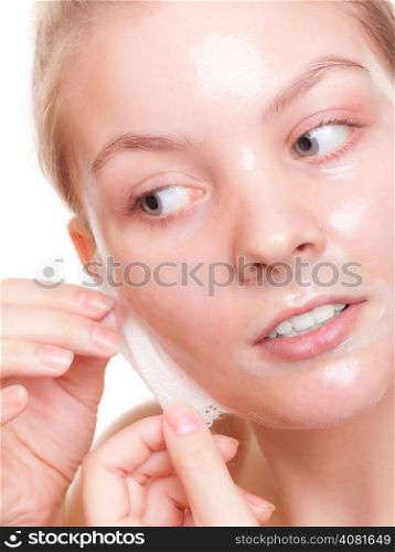 Portrait of girl young woman in facial peel off mask isolated on white. Peeling. Beauty and body skin care. Studio shot.