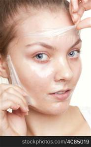 Portrait of girl young woman in facial peel off mask isolated on white. Peeling. Beauty and body skin care. Studio shot.