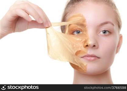 Portrait of girl young woman in orange facial peel off mask isolated on white. Peeling. Beauty and body skin care. Studio shot.