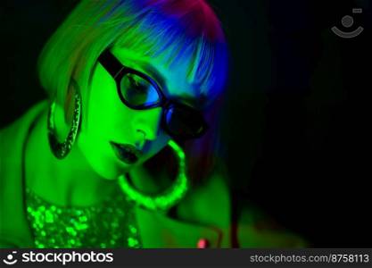 Portrait of glamorous woman under neon green light. Nightclub, trendy outfit. Teenager, zoomer Z-generation. Copy space. High quality photo. Portrait of glamorous woman under neon green light. Nightclub, trendy outfit. Teenager, zoomer Z-generation. Copy space