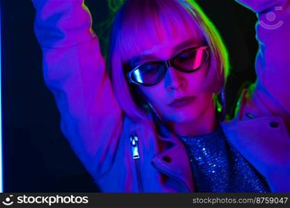 Portrait of glamorous woman under neon purple light. Nightclub, trendy outfit. Teenager, zoomer Z-generation. High quality photo. Portrait of glamorous woman under neon purple light. Nightclub, trendy outfit. Teenager, zoomer Z-generation.