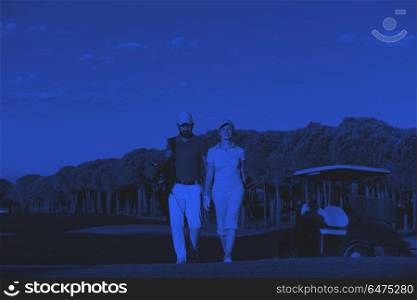 portrait of golfers couple on golf course. portrait of happy young golfers couple on golf course duo tone