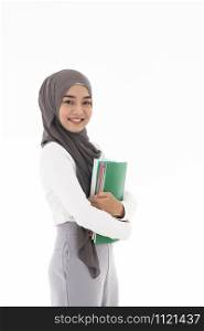Portrait of good-looking Happy young adult Muslim islamic asian university woman holding colorful book. Studio shot on white background.