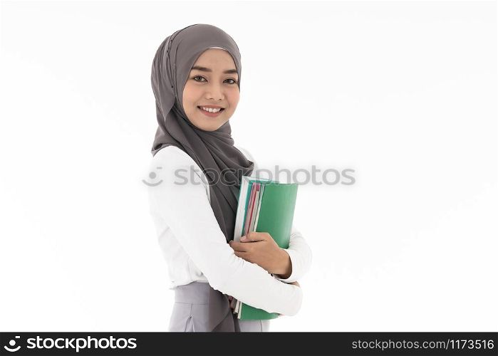 Portrait of good-looking Happy young adult Muslim islamic asian university woman holding colorful book. Studio shot on white background.