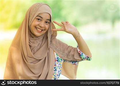 Portrait of good-looking Happy young teenager Muslim islamic asian university girl