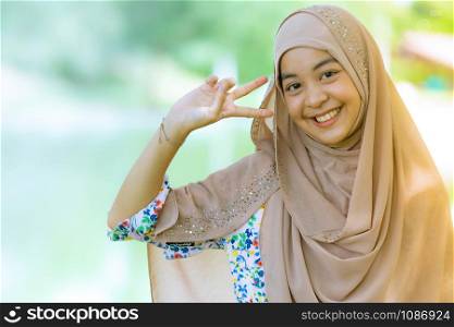 Portrait of good-looking Happy young teenager Muslim islamic asian university girl