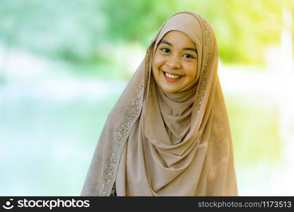 Portrait of good-looking Happy young teenager Muslim islamic asian university girl