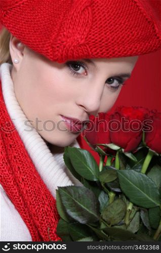 portrait of gorgeous blonde with red roses and assorted clothes
