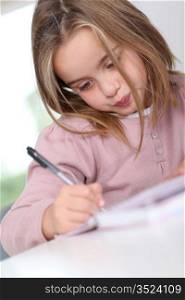 Portrait of grade-schooler doing homework