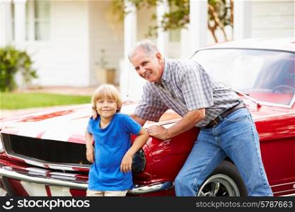 Portrait Of Grandfather And Grandson With Restored Car
