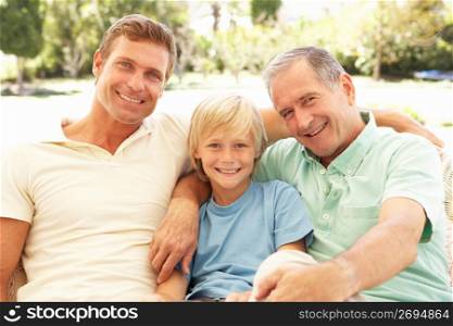 Portrait Of Grandfather, Son And Grandson Relaxing On Sofa