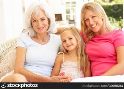 Portrait Of Grandmother, Daughter And Granddaughter Relaxing On Sofa